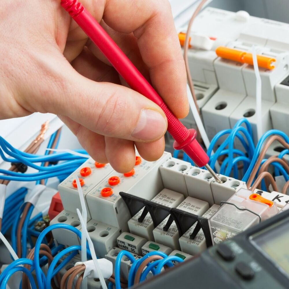 Licensed electrician inspecting panel wiring for code compliance in a Tahoe City, CA property