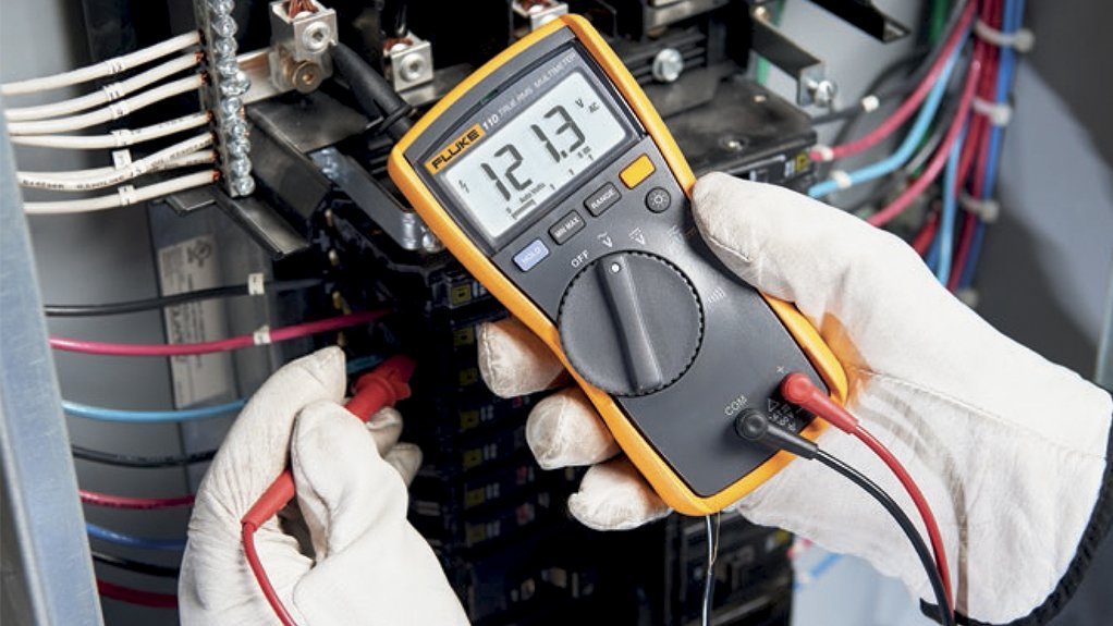 Electrician with meter diagnosing power loss in a Kings Beach rental cabin electrical panel