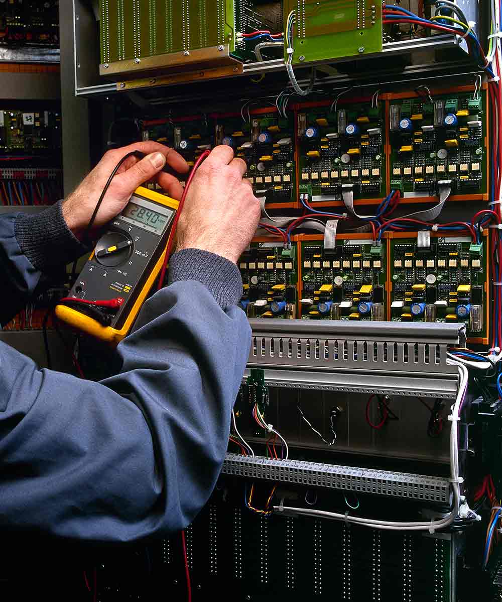 Electrician removing an old electrical panel in a Truckee cabin before installing a new, upgraded panel