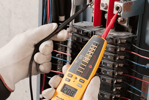 Experienced electrician upgrading a residential electrical panel with advanced tools and code-compliant methods