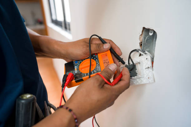 Electrician performing electrical troubleshooting in a Tahoe City, CA residence while testing a wall outlet