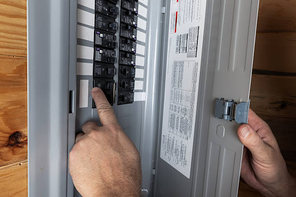 Electrical Troubleshooting in Tahoe City, CA as an electrician checks breaker readings inside a home panel