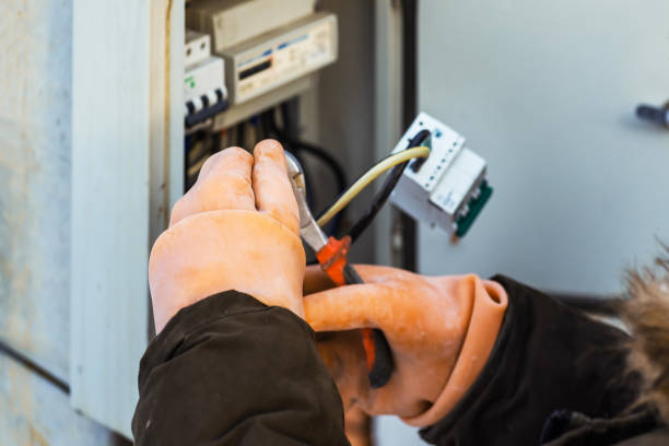 Technician performing Electrical Troubleshooting in a Truckee, CA utility room while checking outlet voltage