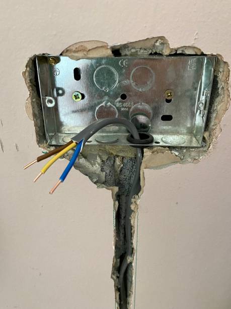 Home Rewiring in Kings Beach, CA in progress as an electrician replaces outdated wiring inside a wall