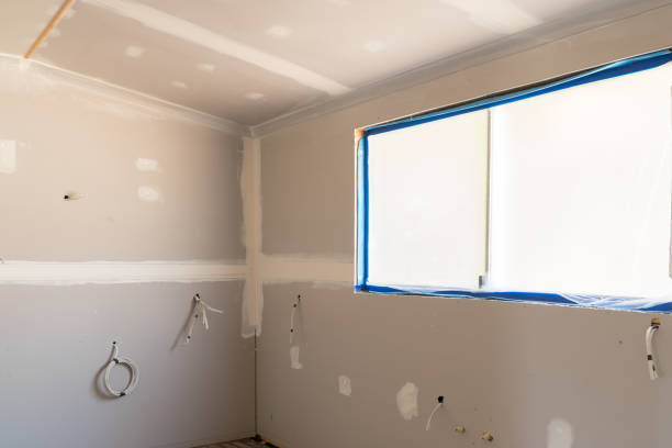 Home Rewiring in Sunnyside, CA underway as an electrician replaces old wiring inside an open wall